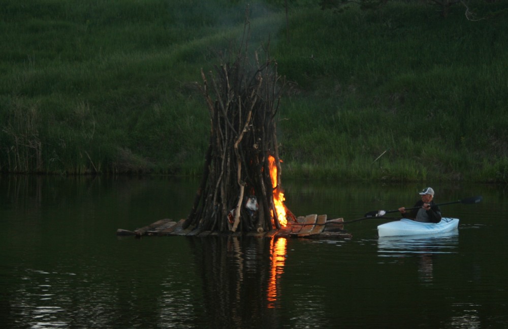 Dale Groop lights the juhannuskokko, or midsummer bonfire, on the Maple River in Frederick, S.D., during Finn Fest on June 15, 2013.