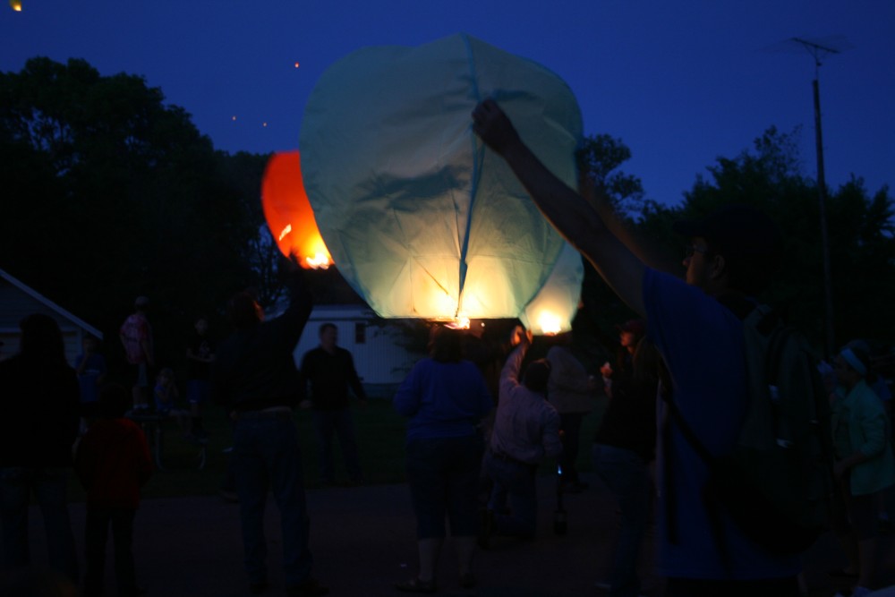 David Losure, right, holds up a sky lantern during Finn Fest in Frederick, S.D., June 15, 2013.