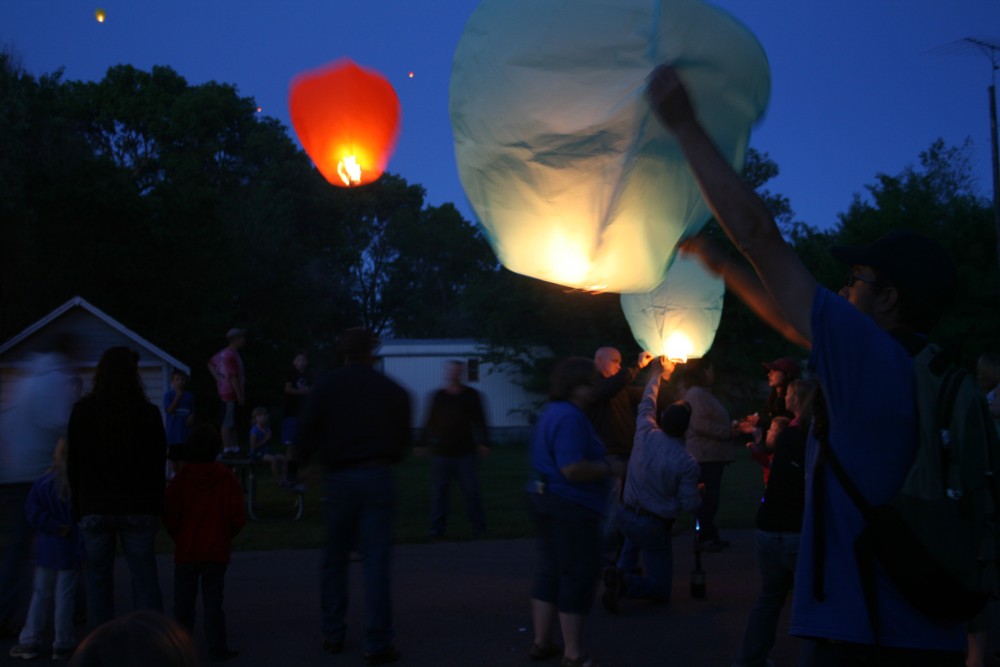 David Losure, right, holds up a sky lantern during Finn Fest in Frederick, S.D., June 15, 2013.