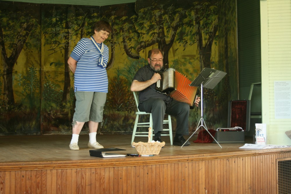 Annikki Marttila of Frederick, S.D., joins Larry "Lauri" Saukko of Bemidji, Minn., in singing a Finnish song during a presentation of traditional music by Saukko at Savo Hall in rural Frederick, S.D., during Finn Fest.
